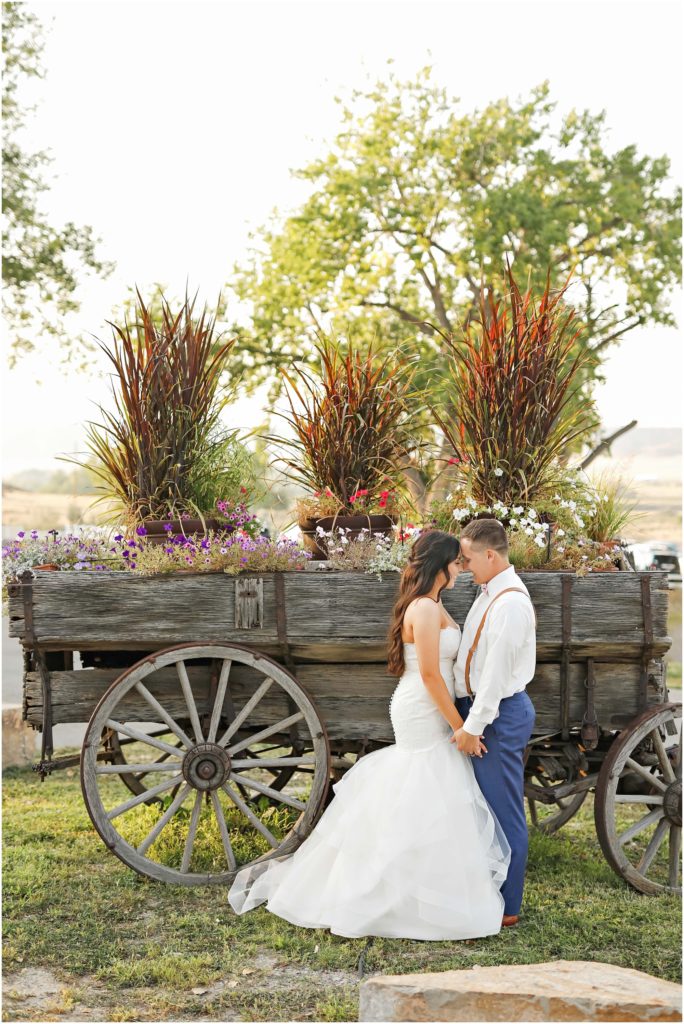 Dreamy Camelot Ranch Wedding Bride and Groom By Wagon