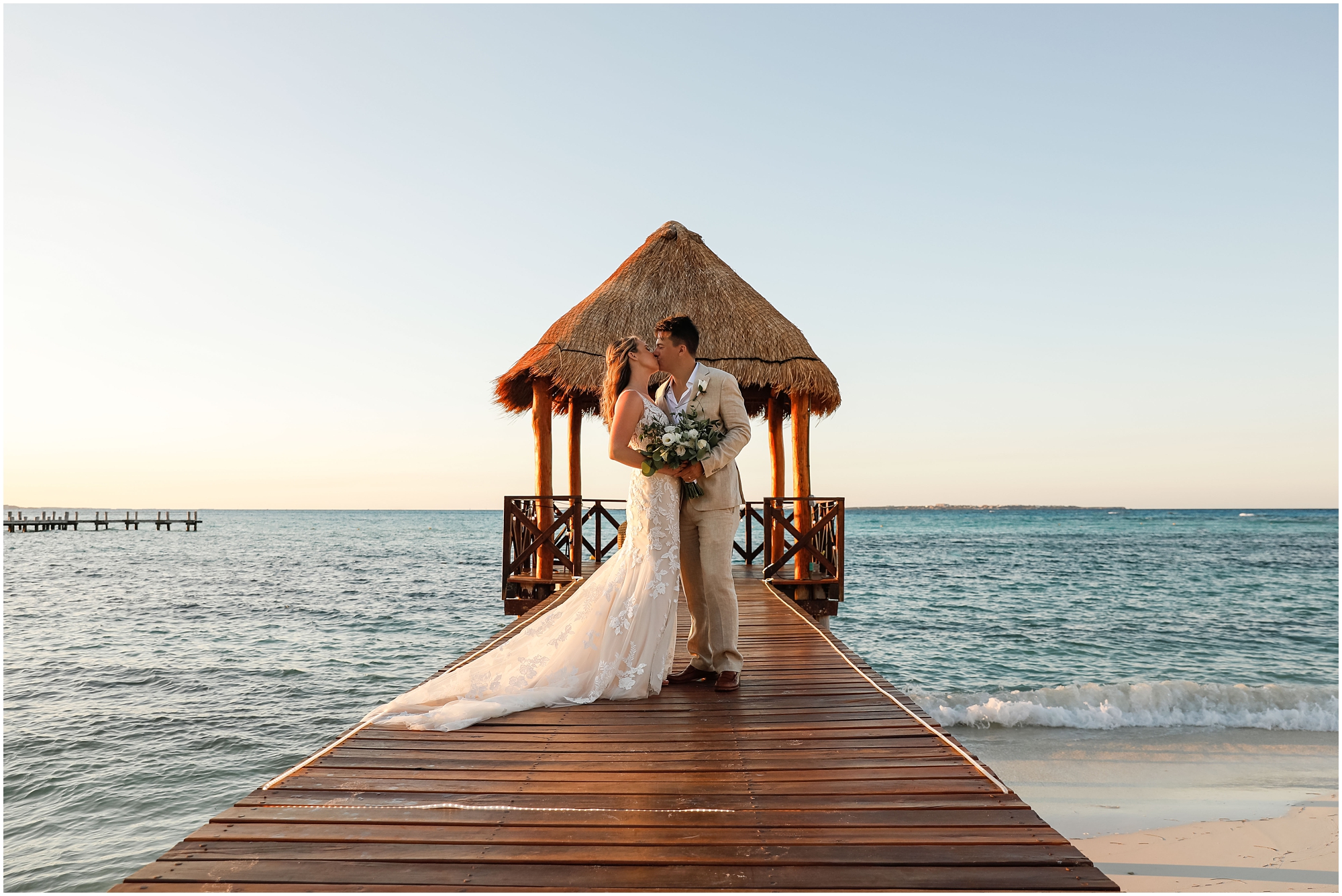 Bride and Groom on dock by ocean in Cancun Mexico