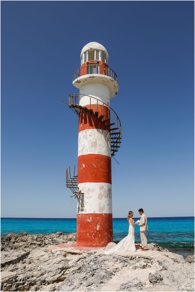 Cancun Destination Wedding Red and White Lighthouse with Bride and Groom reading vows