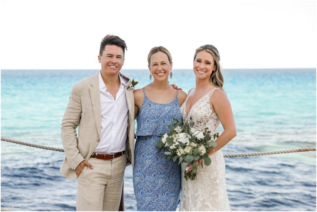 Cancun Destination Wedding Sara Nagel with the Bride & Groom by ocean