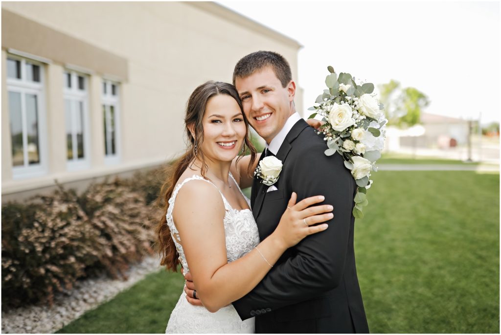 Bride and groom in black suit and white lace dress