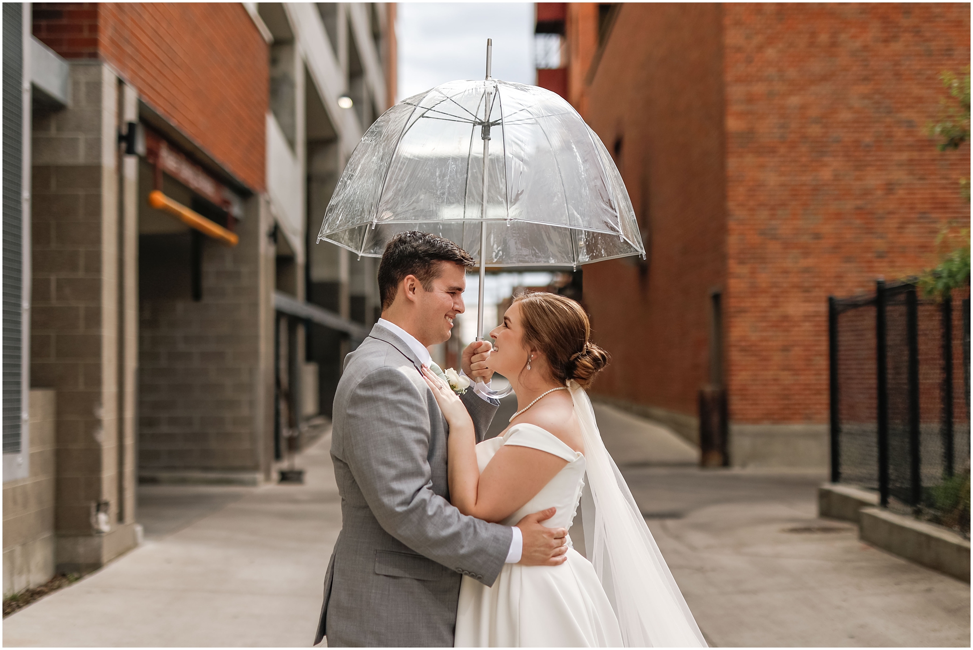 Bride and Groom in downtown Billings with umbrella