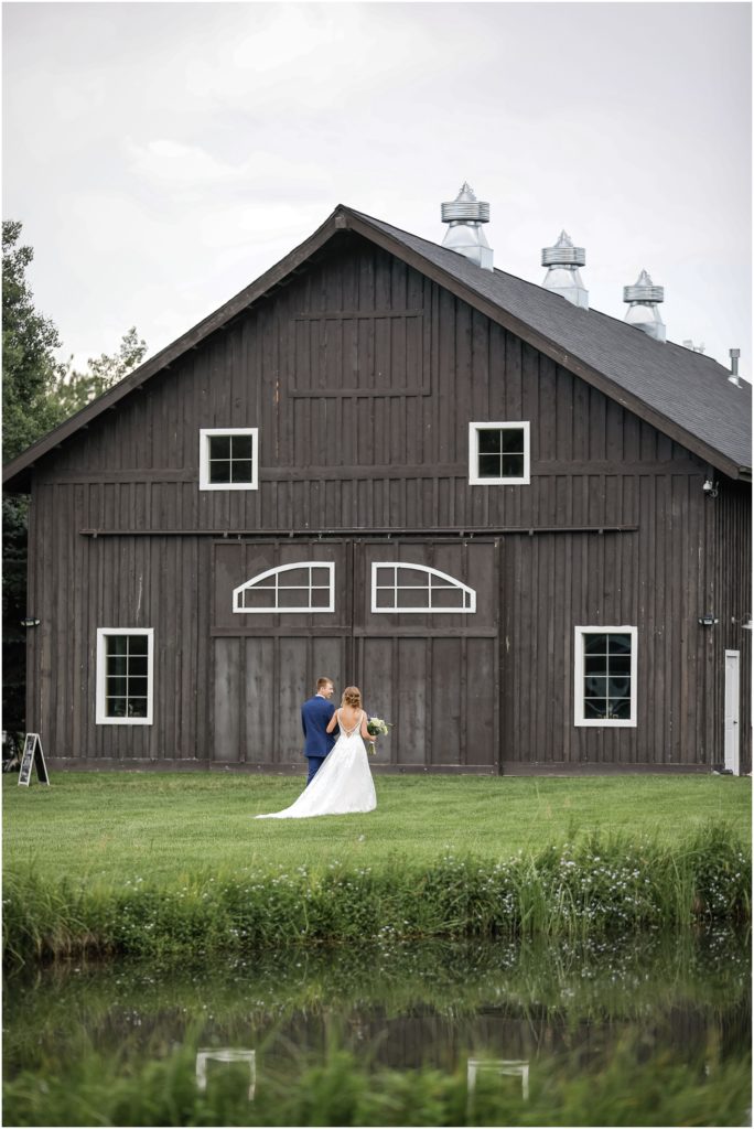 MT Wildflower Wedding Bride and Groom infront of the barn