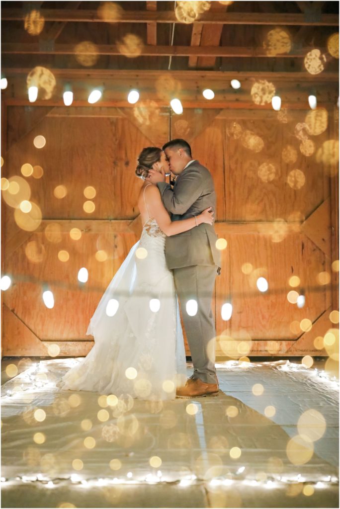 Wyoming Summer Wedding Bride and Groom in Barn with Lights
